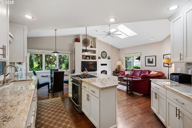 11315 NW Reeves St, Portland, OR 97229 - kitchen with a sink, gas stove, lofted ceiling, dark wood-style flooring, and a skylight