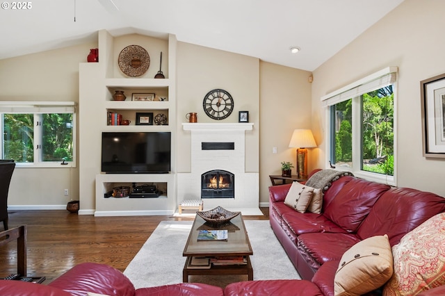 11315 NW Reeves St, Portland, OR 97229 - living area with plenty of natural light, wood finished floors, lofted ceiling, a warm lit fireplace, and ceiling fan