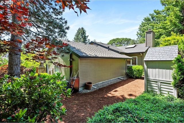 11315 NW Reeves St, Portland, OR 97229 - back of property with a shingled roof and a chimney