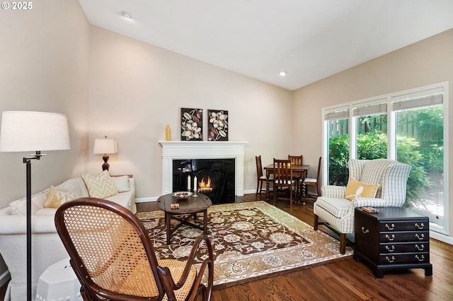 11315 NW Reeves St, Portland, OR 97229 - living room featuring vaulted ceiling, healthy amount of natural light, wood finished floors, a fireplace with flush hearth, and baseboards