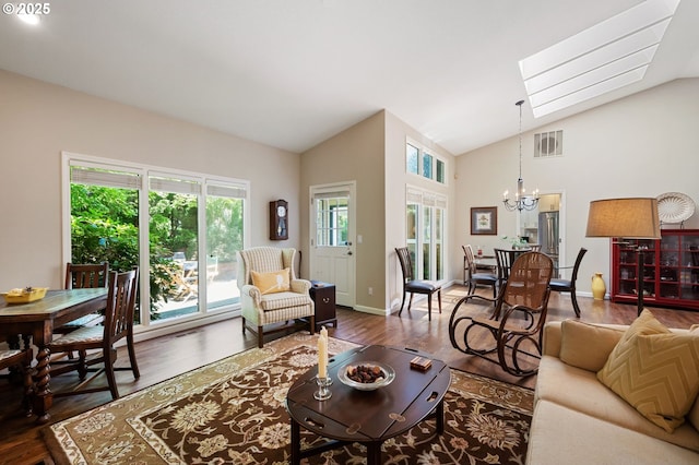 11315 NW Reeves St, Portland, OR 97229 - living area with a chandelier, wood finished floors, a skylight, baseboards, and high vaulted ceiling
