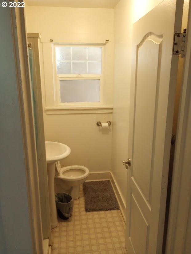 bathroom with toilet and tile floors