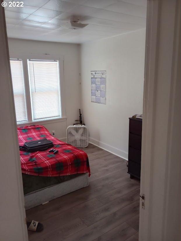 bedroom with dark wood-type flooring