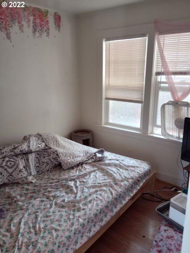 bedroom with dark hardwood / wood-style floors