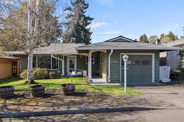 ranch-style house with driveway, an attached garage, roof with shingles, and a front yard