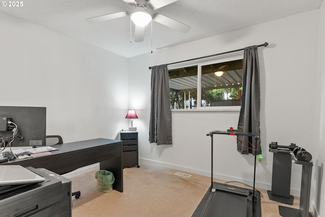 office with baseboards, visible vents, a textured ceiling, and light colored carpet