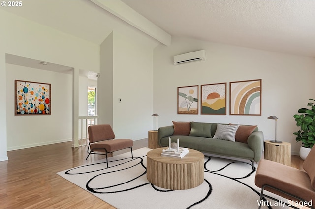 living room with baseboards, beamed ceiling, a wall mounted air conditioner, and wood finished floors
