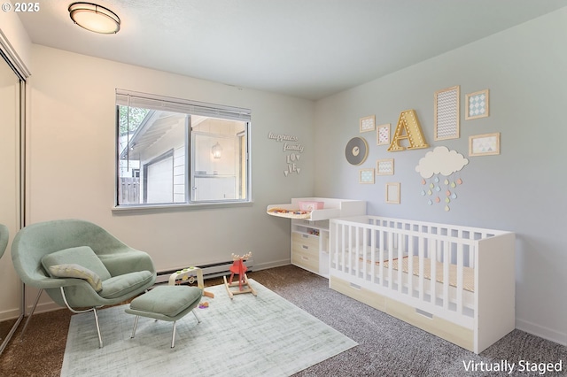 bedroom featuring baseboards, a baseboard heating unit, a crib, and carpet