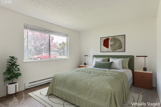 bedroom with carpet floors, a textured ceiling, and a baseboard heating unit