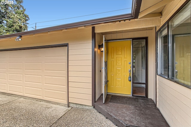 view of exterior entry with a garage