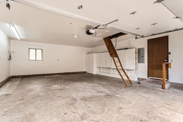 garage with baseboards, a garage door opener, and electric panel