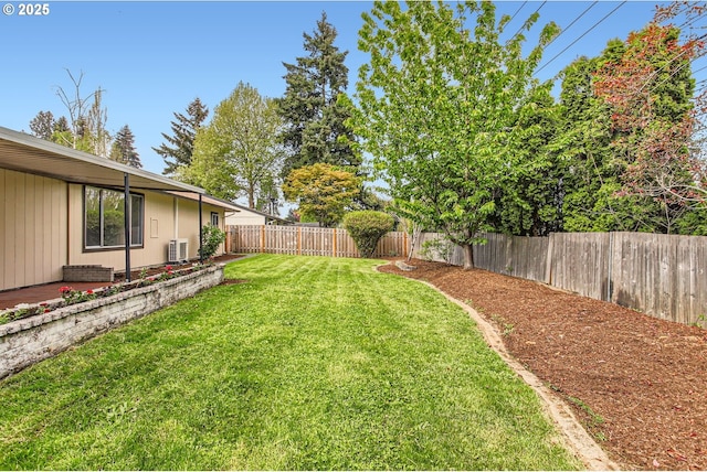 view of yard with a fenced backyard and central AC unit