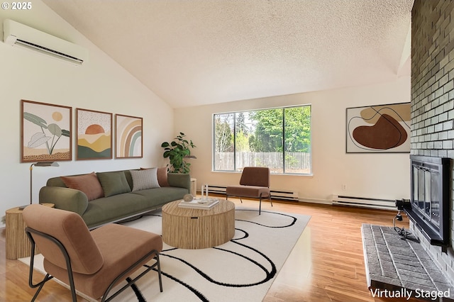living room featuring baseboard heating, lofted ceiling, a wall mounted air conditioner, and wood finished floors