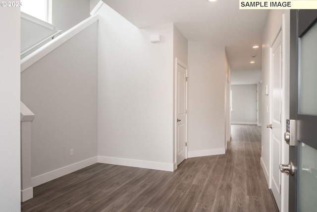 corridor with dark hardwood / wood-style flooring