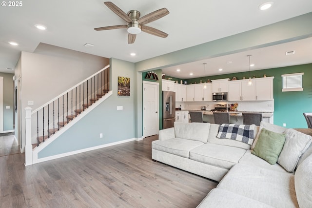2570 SE Kane Ave, Gresham, OR 97080 - living room featuring wood finished floors, stairway, ceiling fan, recessed lighting, and baseboards