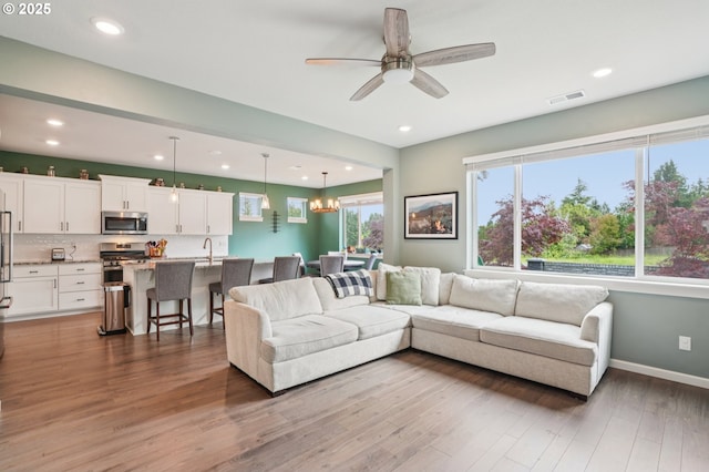 2570 SE Kane Ave, Gresham, OR 97080 - living room featuring wood finished floors, ceiling fan, baseboards, and recessed lighting