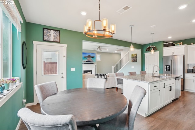 2570 SE Kane Ave, Gresham, OR 97080 - dining area featuring ceiling fan, a chandelier, light wood-style floors, a fireplace, and recessed lighting