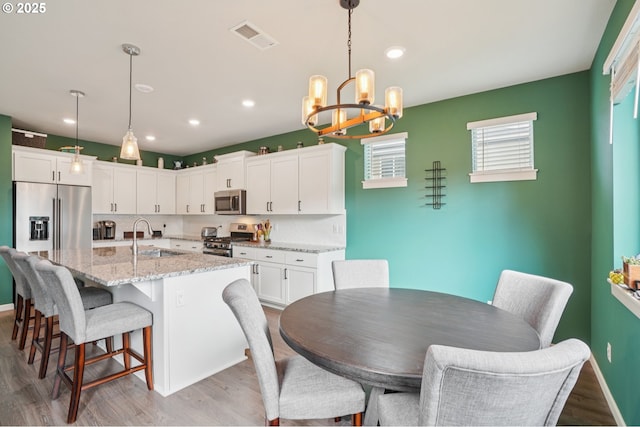 2570 SE Kane Ave, Gresham, OR 97080 - dining space featuring a chandelier, wood finished floors, recessed lighting, and baseboards