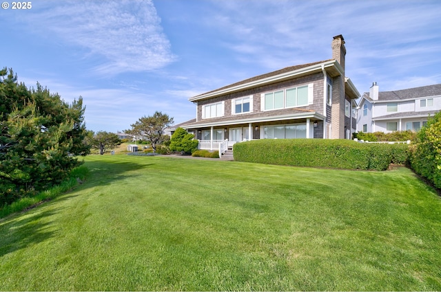 4830 Butterfly Ln, Gearhart, OR 97138 - back of property with a chimney, a porch, and a yard