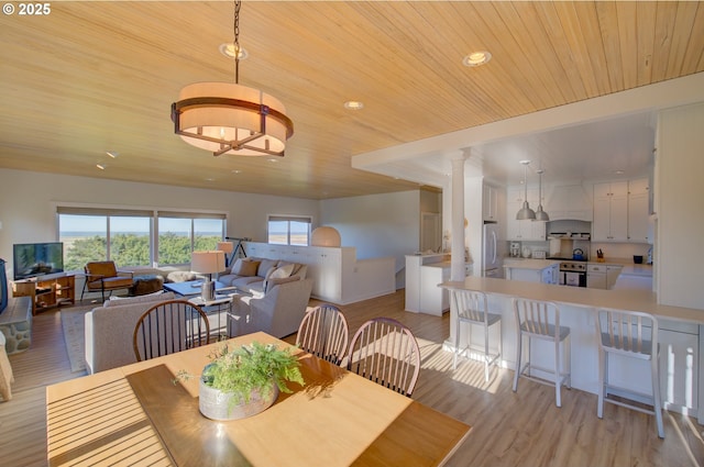 4830 Butterfly Ln, Gearhart, OR 97138 - dining area with ornate columns, wooden ceiling, light wood finished floors, and recessed lighting