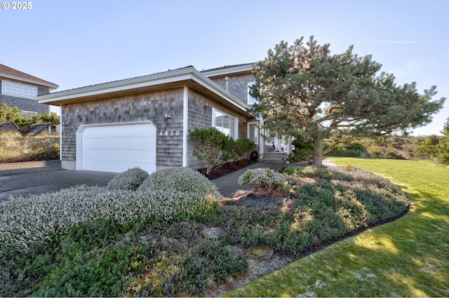 4830 Butterfly Ln, Gearhart, OR 97138 - view of side of home with an attached garage, driveway, and a lawn