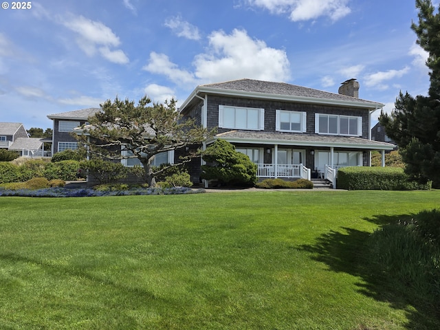 4830 Butterfly Ln, Gearhart, OR 97138 - rear view of house with a chimney, a porch, and a yard