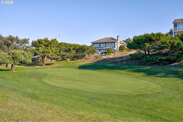4830 Butterfly Ln, Gearhart, OR 97138 - surrounding community with golf course view, a yard, and a putting green