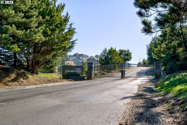 4830 Butterfly Ln, Gearhart, OR 97138 - view of asphalt street with a gate and a gated entry