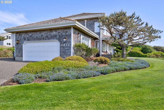 4830 Butterfly Ln, Gearhart, OR 97138 - view of side of home featuring a yard, an attached garage, and driveway