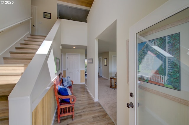 4830 Butterfly Ln, Gearhart, OR 97138 - entrance foyer with stairs, light wood finished floors, a towering ceiling, and baseboards