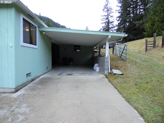 view of car parking with a carport and a yard