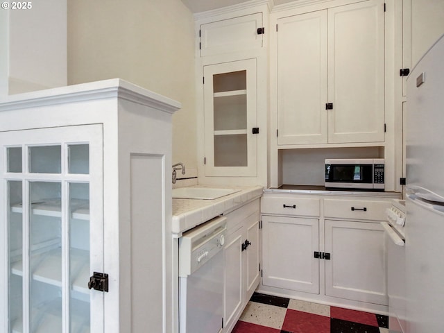 20 NW 16th Ave Unit 211, Portland, OR 97209 - kitchen with dishwasher, stainless steel microwave, a sink, and white cabinetry