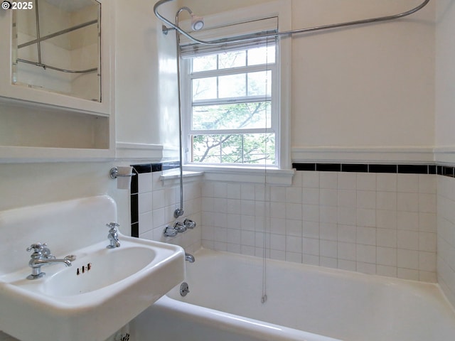 20 NW 16th Ave Unit 211, Portland, OR 97209 - bathroom with healthy amount of natural light, a sink, and wainscoting
