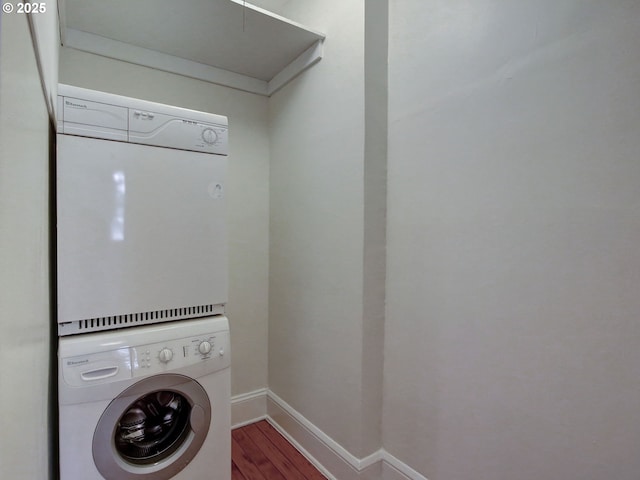20 NW 16th Ave Unit 211, Portland, OR 97209 - washroom featuring stacked washer and clothes dryer, wood finished floors, and baseboards