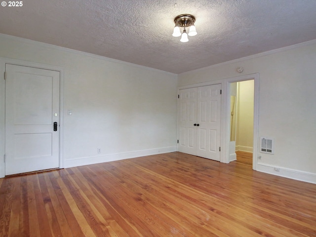 20 NW 16th Ave Unit 211, Portland, OR 97209 - empty room with a textured ceiling, light wood finished floors, baseboards, and ornamental molding
