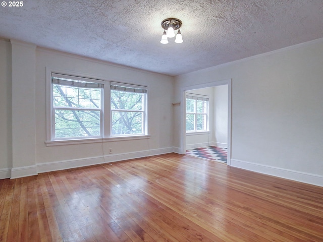 20 NW 16th Ave Unit 211, Portland, OR 97209 - unfurnished room with a textured ceiling, hardwood / wood-style floors, baseboards, and ornamental molding