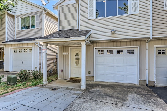 doorway to property with a garage