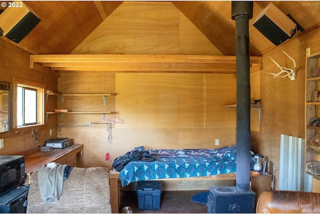 interior space featuring wooden ceiling, lofted ceiling, and a wood stove