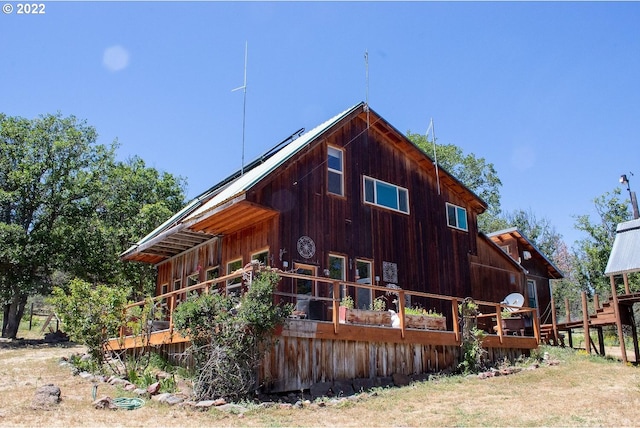 view of side of home with a deck