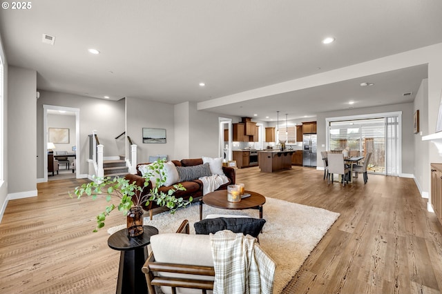 5719 N 87th Ave, Camas, WA 98607 - living area featuring baseboards, light wood-style floors, stairway, and recessed lighting