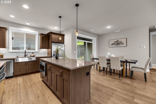 5719 N 87th Ave, Camas, WA 98607 - kitchen with a sink, stainless steel appliances, tasteful backsplash, light wood finished floors, and recessed lighting