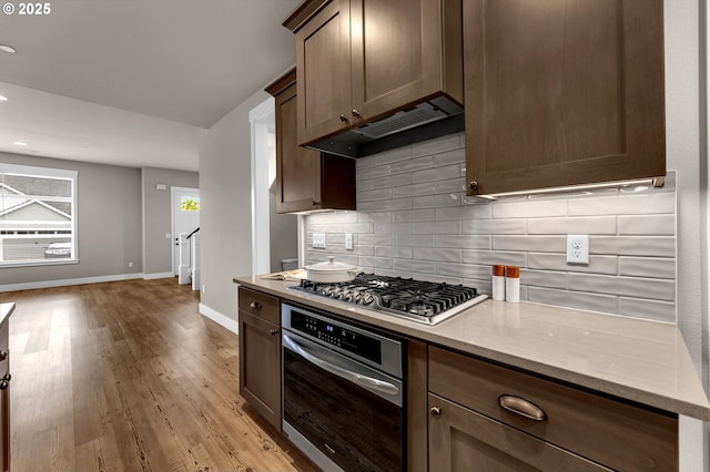 5719 N 87th Ave, Camas, WA 98607 - kitchen with stainless steel appliances, backsplash, baseboards, light wood-type flooring, and light stone counters