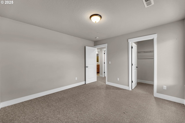 5719 N 87th Ave, Camas, WA 98607 - unfurnished bedroom featuring baseboards, carpet floors, a walk in closet, and a closet