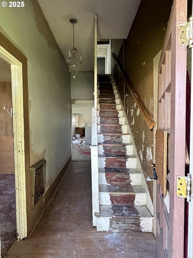 214 W Broadway St, Goldendale, WA 98620 - staircase featuring hardwood / wood-style floors, a notable chandelier, and heating unit