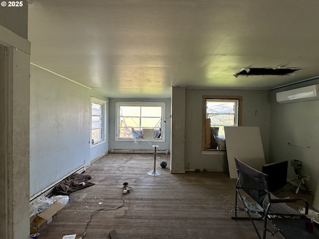214 W Broadway St, Goldendale, WA 98620 - interior space featuring a baseboard radiator, a wall mounted AC, and wood finished floors