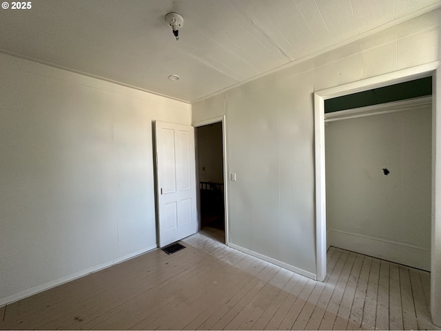 214 W Broadway St, Goldendale, WA 98620 - unfurnished bedroom featuring visible vents, a closet, baseboards, and wood finished floors