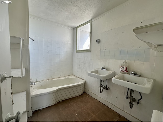 214 W Broadway St, Goldendale, WA 98620 - bathroom with a textured ceiling, tile patterned floors, a sink, and tile walls