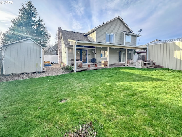 back of house with a yard and a storage shed