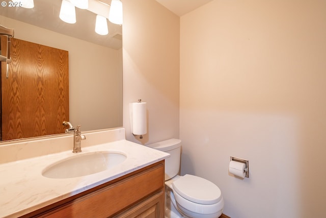 bathroom featuring toilet and vanity