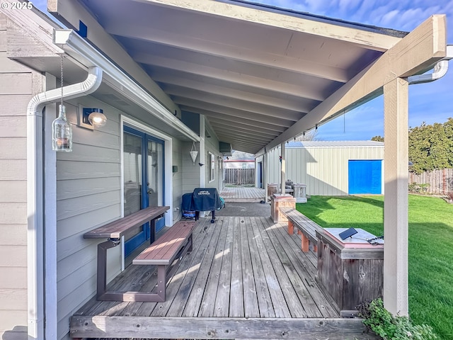 wooden terrace featuring a yard